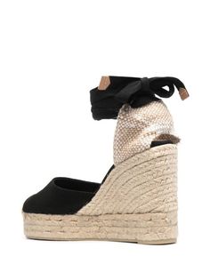 Castañer Carina Wedge Espadrilles - Farfetch Chic Espadrilles With Wedge Heel And Woven Sole, Chic Espadrilles With Woven Sole And Wedge Heel, Chic Espadrilles With Textured Wedge Sole, Chic Straw Espadrilles With Round Toe, Chic High Heel Espadrilles With Woven Sole, Chic Wedge Sandals With Woven Sole And Round Toe, Chic High Heel Straw Espadrilles, Black Straw Heels For Spring, Spring Black Straw Heels