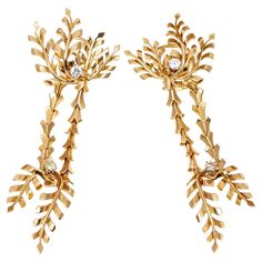 These 18K yellow gold impressive, sophisticated and beautifully made earrings are a leaf motif. The tops are set with four curved leaves, with a round brilliant cut diamond, prong set, set at the base. Suspended from the top are two vertical, articulated rows, from which dangle another two curved leaves, reversed from the top, and also set with a round brilliant cut diamond. The total diamond weight for the earrings is approximately 0.40 TCW, and the earrings have posts with omega style backs. Marks: Serialized; no gold mark, tested 18k Dimensions: 3 1/4" long x 1 1/8" wide Weight: 15.9 gross dwt Condition: Overall very good estate condition, one diamond is slightly loose in its setting. As mentioned the earrings are serialized and are of fine craftsmanship - they may be by Pierre Sterle, Leaf Motif, Leaf Earrings, Round Brilliant Cut Diamond, Brilliant Cut Diamond, Round Brilliant, Prong Setting, The Row, Jewelry Earrings Dangle, Dangle Earrings