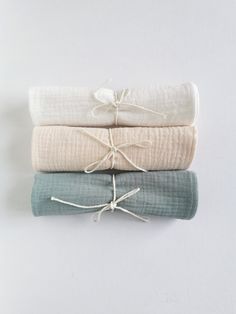 three folded towels tied together on top of each other