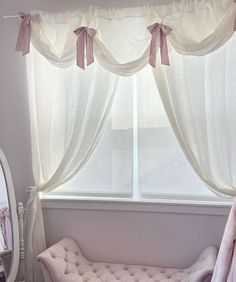 a window with curtains and a bench in front of it, next to a mirror