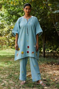 Blue kaftan with floral applique work and small embrodiered buttis. Paired with an embroidered pant. - Aza Fashions Summer Cotton Tunic Sets, Spring Cotton Tunic Set, Spring Cotton Kaftan With Floral Embroidery, Floral Embroidered Loungewear Sets For Summer, Floral Embroidery Loungewear Sets For Summer, Blue Chikankari Embroidery Sets For Spring, Summer Straight Kurta Pant Set With Resham Embroidery, Bohemian Straight Kurta Sets For Spring, Summer Pant Set With Resham Embroidery And Straight Kurta