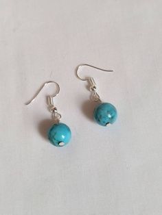 Turquoise natural stone bead dangle earrings handmade 1.25 inch Simple yet elegant turquoise natural stone drop earrings 1.25 inch length 10mm beads Lightweight  Nickel free, hypoallergenic silver plated hook ear wires with clear backs to help keep in place  Packaged in a beautiful organza bag, ready for gift giving Surprise included with each order Follow my shop to see more handmade jewelry JEWL 465 If you have any questions please message me You can see more of my created jewelry at https://w Chip Bead Jewelry, Turquoise Earrings Dangle, Diy Jewelry Unique, Handcrafted Artisan Jewelry, Chip Beads, Beaded Dangle Earrings, Seed Bead Necklace, Lovely Jewellery, Beaded Dangles