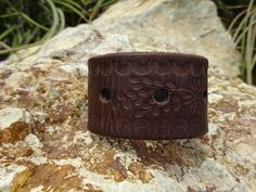 This leather cuff is made from a upcycled leather belt.  It has a really cool design where the leather is stamped with a floral design.  The subtle design gives this cuff a fun visual effect. So fun. The cuff closes in the back with one gold colored snap.   It will fit a 6 3/8 (16.25 cm) inch wrist comfortably.    This cuff would look great on anybody! Cuff measurements: length: 8.0 inches (20.25 cm) width: 1.5 inches (3.75 cm) inside from snap to snap: 6 5/8 inches (about 16.75 cm) will fit: a Rustic Cuff Bracelet For Festivals, Brown Stamped Bohemian Cuff Bracelet, Bohemian Stamped Brown Cuff Bracelet, Brown Bohemian Stamped Cuff Bracelet, Rustic Brown Stamped Cuff Bracelet, Rustic Stamped Leather Bracelet, Leather Creations, Flower Cuff Bracelet, Flower Cuff