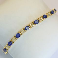 Own This Stunning 14k Gold Sapphire And Diamond Tennis Bracelet. This Beautiful Piece Will Get You Daily Compliments! Primary Stone Is Blue Sapphire, With 4 Small Diamonds Between Each Sapphire. Estimated Diamond Weight Is 1.2 Carats. Total Weight: 11.45 Grams Bracelet Length: 7 Inches Precious Metal: 14k Yellow Gold Precious Stones: Natural Blue Oval Sapphires: Qty: 16, 8.32 Carats, Oval Cut 6 Mm X 4 Mm White Round Diamonds: 1.2 Carat, Qty 60 Hallmark: 14k Gia Appraisal In July 2023 Put Replace Diamond Tennis Bracelet, Tennis Bracelet Diamond, Precious Metal, 2 Carat, Tennis Bracelet, Oval Cut, Womens Jewelry Bracelets, Precious Metals, Blue Sapphire