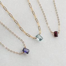 "Baguette Gemstone Necklaces for Women Add a touch of sparkle with this dainty necklace that features a baguette gemstone in your choice.  Handmade just for you by wrapped genuine gems in silver or gold chain, this necklace is simple yet chic.  Choose garnet, Iolite or blue topaz  D E T A I L S -Dainty gem approx. 9mm  - Choose garnet, Iolite (navy) or swiss blue topaz These are natural stones that are perfectly imperfect.   D E T A I L S *Genuine Natural Gemstone in your choice of garnet, Iolite (navy) or swiss blue topaz *Approx 9-11mm  *14kt gold filled demi or nixi chain *100% 14k gold filled or sterling silver  Wrapped by hand just for you!  LENGTH Available in 16, 18 or 20 inches. *Model is wearing 18\" in photos HOW TO PERSONALIZE *Select your choices from the drop down menu to crea Handmade Elegant Birthstone Necklace For Everyday, Handmade Elegant Everyday Birthstone Necklace, Minimalist Necklace With Rectangular Stone For Gift, Minimalist Necklace With Rectangular Stone As Gift, Minimalist Rectangular Stone Necklace For Gift, Handmade Necklace With Rectangular Stone For Gift, Handmade Rectangular Stone Necklace As Gift, Handmade Rectangular Stone Necklace For Gift, Dainty Gemstone Necklaces For Parties