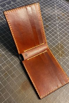 Traditional bifold - Tobacco Red  * This wallet is 100% handmade * includes 8 card pockets with a full size cash pocket  * leather colors are Tobacco Red and Double Black * Wickett & Craig natural vegetable tanned leather * The leather is dyed, oiled and waxed by hand. * hand punched and saddle stitched,  burnished and waxed edges.  * We seal each wallet with Aussie cream, it gives the wallet heat, cold, water and scratch resistance without changing how the wallet looks or feels.  * Lifetime guarantee  If you have any questions or a custom order request, please feel free to send me a message. For any other details you can go to our website www.benningtonleather.com Everyday Cognac Bifold Wallet, Cognac Bifold Wallet With Interior Card Slots, Handmade Classic Trifold Wallets, Classic Handmade Brown Trifold Wallet, Classic Handmade Leather Trifold Wallet, Handmade Classic Leather Wallet, Classic Handmade Leather Wallet, Custom Wallets With Card Slots For Everyday Use, Custom Wallet With Card Slots For Everyday Use