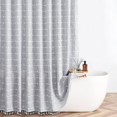 a bath tub sitting next to a shower curtain