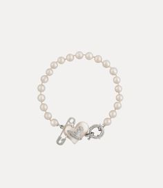 Pearls remain an essential element of the house’s iconography, evoking both a sense of luxury and rebellion. This season's Orietta Pearl bracelet features a row of glass-based Swarovski pearls, adorned with the iconic asymmetric heart motif and an orb at the centre, embellished with a safety pin detail - a nod to Vivienne's punk-inspired, non-conformist aesthetic. Jewelry Accessories Pearl, Vivian Westwood Necklace Green, Vivviene Westwood Bracelet, Vivene Westwood Bracelet, J’adior Bracelet, Vinnie Westwood Bracelet, Vienna Westwood Jewelry, Vivien Westwood Earrings, Vivien Westwood Bracelet