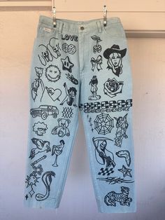 a pair of blue jeans with drawings on them