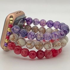 Custom handmade beaded watch band compatible with Apple Watch. Watch band made with Purple and Red Dragon Veined Stone Agate, and White Gold Veined Howlite beads. Please use the drop-down to select your connector and wrist size. I can also make one custom to your wrist measurement if you include your wrist size in your order (example in last photo). I have many different colors/styles/materials of beads. If you are looking for a specific color please send me a message and I may have it! These are handmade items so they may vary in pattern placement. Due to differences in screen settings, colors may differ slightly between photos and the physical product. Please feel free to send me a message if you have questions regarding availability of patterns, quantities, or sizes. I often have patter Adjustable Beaded Watch Bands For Gift, Multicolor Adjustable Apple Watch Band Gift, Adjustable Multicolor Apple Watch Band As A Gift, Gift Multicolor Adjustable Apple Watch Band, Adjustable Multicolor Apple Watch Band With Round Beads, Adjustable Apple Watch Band With Extender As Gift, White Beaded Apple Watch Band As Gift, Adjustable Round Bracelet Strap Watch Bands, White Beaded Apple Watch Band Gift