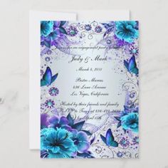 an elegant wedding card with blue flowers and butterflies on the front, in silver foil