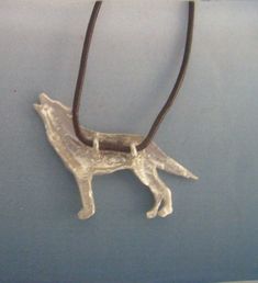 WOLF SILVER PENDANT This pendant Wolf is finely carved and illustrates the wolf in a typical gesture where is howling, perhaps to the moon... dimensions of the pendant silver wolf: 3 cms x 2.4 cms available with silver cord or with leather cord adaptable in length by sliding knot leather cord included MAGIC PROPERTIES OF THE WOLF SYMBOL (for the silver wolf pendant) The wolf pendant is a good amulet for cultivating inner wisdom. Wolf amulets give confidence and desire for freedom, or to balance Sterling Silver Wolf Design Jewelry Gift, Sterling Silver Wolf Design Necklace As Gift, Sterling Silver Necklace With Wolf Design For Gift, Sterling Silver Necklace With Wolf Design As Gift, Sterling Silver Jewelry With Wolf Design For Gift, Wolf Symbol, Wolf Pendant, Wolves Pendants, Magic Symbols