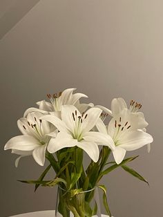 a vase filled with white flowers on top of a table