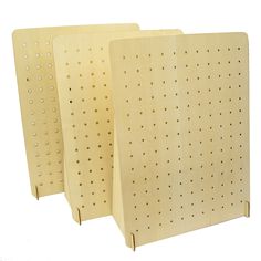 three wooden peg boards with holes on them