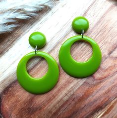 Moss Green Drop Hoop Earrings. I have made these fabulous statement drop hoop earrings in resin, using moss green colouring. The drop hoops have a classic 1950's style and measure 42mm in diameter. They are fixed to the top studs which are 17mm in diameter and have a 6mm dome. They are finished with stainless steel earring posts and have an total drop of 62mm. They are incredibly lightweight making them easy to wear. They will look amazing with your vintage summer dresses and also jeans and tops for a 50's rockabilly look. Please get in touch if you'd like these in a different colour combination, tops and hoops can be mixed or alternated if you would like mis-matched earrings. You can find more of my 50s and 60s drop hoop earrings here: www.etsy.com/uk/shop/RosieMays?section_id=25135598 Th Retro Green Drop Earrings, Retro Round Earrings For Party, Retro Party Earrings, Retro Hoop Earrings For Parties, Retro Green Earrings For Party, Small Hoop Retro Earrings For Pierced Ears, Green Retro Party Earrings, Retro Dangle Earrings, Small Retro Hoop Earrings