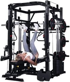 a woman is doing exercises on the smith machine