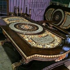 an ornately decorated dining table with matching chairs