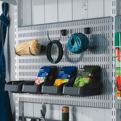 a metal shelf filled with lots of items and hanging from it's sides next to a blue umbrella