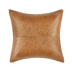 a brown leather pillow on a white background