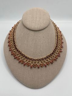 This handmade women's rose gold necklace is made with bronze and various shades of rose gold beads, including rose gold seed beads.  It closes with a rose gold toggle clasp. It is lightweight and compliments most attire. Adjustable Gold Beaded Copper Necklace, Elegant Handmade Rose Gold Beaded Necklaces, Gold Copper Necklace With Round Beads, Elegant Brown Beaded Necklace With Spacer Beads, Copper Jewelry With Gold Round Beads, Handmade Copper Beaded Necklaces With Round Beads, Handmade Copper Beaded Necklaces, Rose Gold Necklaces With Round Tiny Beads, Elegant Adjustable Bronze Beaded Necklace