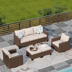 an outdoor patio furniture set sitting next to a swimming pool