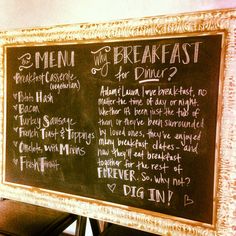 a blackboard with writing on it in front of a wall mounted sign that says menu for breakfast