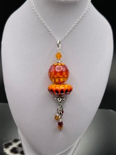 I designed and created this necklace using artisan lampwork beads.  I used a stunning round petal bead and a matching disc bead with bright red and orange colors.  I added Bali silver bead caps and sterling silver dangles underneath.  Everything is securely wire wrapped and suspended from a 20" oval link silver chain. It has a lobster clasp closure.  This will come gift boxed. Follow me on Facebook and IG at NYC Fashion Connection. Fire Color, Lampwork Necklace, Statement Bib Necklace, Bali Silver, White Rhinestone, Bead Caps, Animal Jewelry, Lampwork Beads, Silver Beads