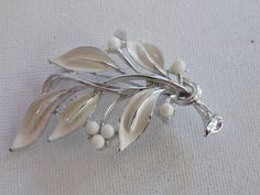 "Silver White bead Enamel Branch Leaves Brooch Pin Signed Lisner Good condition with some minimal wear to enamel 2 1/8\" by a little over 1 1/2\" I appreciate you taking the time to stop by my store. If I can be of any assistance, please let me know. For more beautiful vintage jewelry, click here: http://www.etsy.com/shop/meetingofthefinds. For US customers: If you would like this item insured, please convo me before purchase and I will add that cost in for you." Branch Leaves, Sioux City, Tiny Bird, Loop Earrings, Fall Gifts, I Appreciate You, Pearl Brooch, Appreciate You, Gold Wire