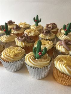 cupcakes with frosting and cactus decorations on them