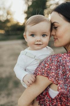 a woman holding a baby in her arms