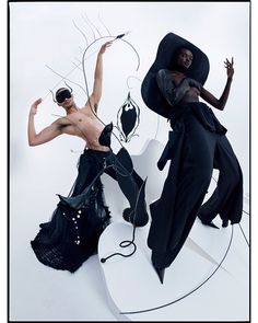 two women in black clothing are posing on a surfboard