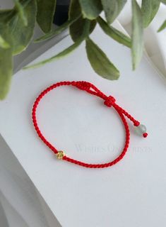 "This bracelet is a day-to-day accessory. Wear this handmade beautiful red string bracelet and feel the luck, good fortune, and energy of the red color. Material: - Golden plated floral charm 5mm - Green jade bead 6mm - 0.8mm professional woven waxed red string ♥ Packaging: All jewelry comes in a beautiful and careful packaging. ❖ The gemstones are natural, each stone is unique and beautiful so please expect slight variations in color, texture, and size. ❖ The bracelet is made to order, as the bracelet length must be based on your wrist size. All orders are final sale as they are custom bracelets. Please double check your wrist size before ordering ❖ BRACELET SIZE  We make all our bracelets to actual \"bracelet size\" or \"bracelet length\" (not \"wrist size\") Select your preferred bracel Red Lucky Bracelet, Red Bracelet For Protection, String Bracelet Designs, Lucky Charm Bracelet, Red Bracelet, Red String Bracelet, Bracelets Design, Lucky Bracelet, Diy Bracelets Easy