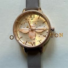 Enjoy Gorgious And V Unique Looking Olivia Burton Ob16gd06 Celestial 3d Bee Demi Dial Watch With 34mm Silver Tone Sunray Face With Rosegold & Silver Glitters & Flacks In The Back Ground & Lighter Rosegold 3d Bee Figurine On The Dial & Rosegold Roman Numerals Hourmarkers & Rosegold Hands & Rosegold Bezel With Coinedge Trim Around Its Bezel & Grey Leather Band. Its Original Retail Price Is $225 & Overheads Enjoy The Gorgeous Watch At Great Discount. Bee Figurine, Olivia Burton, Roman Numerals, Grey Leather, Silver Glitter, Leather Band, Accessories Watches, Silver Tone, Bee