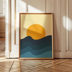 an art print is on the floor in front of a wall with a wooden frame