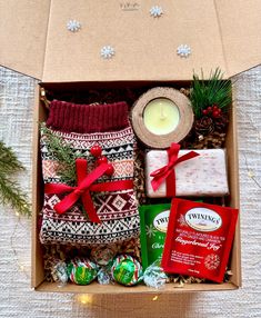 a box filled with christmas gifts and candles