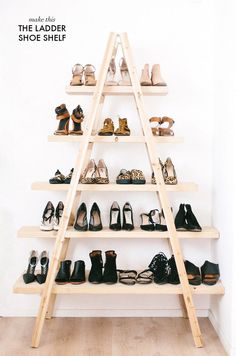 there is a ladder that has many pairs of shoes on it in front of a white wall