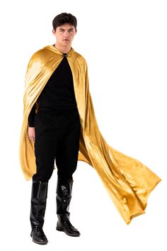 a young man dressed in a gold cape and black pants, standing with his hands on his hips