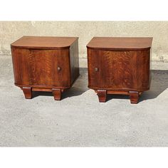 two wooden chests sitting side by side on concrete