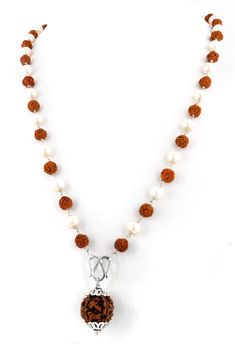 an orange and white beaded necklace on a white background