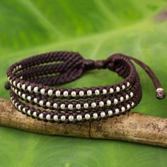 Silver beads of Karen hill tribe origin shine brightly among the dark maroon braids that shape this trendy wristband. Napapat crafts the bracelet by hand featuring a sliding knot that allows it to be adjusted to the desired length. Adjustable Bohemian Braided Bracelets For Festivals, Handmade Bohemian Braided Bracelet For Festivals, Adjustable Bohemian Braided Bracelet For Festivals, Spiritual Beaded Braided Bracelets For Festivals, Adjustable Beaded Bracelets For Beach Festivals, Hippie Braided Bracelets With Round Beads For Festivals, Adjustable Beaded Bracelet For Beach Festivals, Brown Bohemian Bracelets For Festivals, Spiritual Brown Friendship Bracelets For Festivals