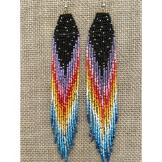 two pairs of beaded earrings with black, red, and blue feathers on them