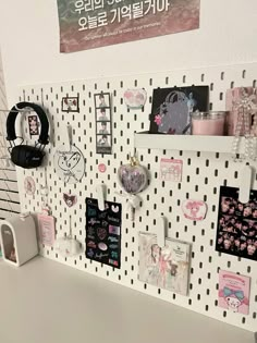 there are many magnets and pictures on the wall in this office area, all decorated with black and white polka dots