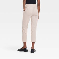 These High-Rise Tapered Ankle Knit Pull-On Pants from A New Day™ provide a polished look that blends comfort with elegance. These pull-on pants are made from a soft fabric blend with added spandex for comfortable wear that moves with you. Plus, they're tailored in a flattering high-rise, ankle-length silhouette and feature a tapered-leg cut for added flair. An elasticized waistband and slash pockets on the sides complete the design with functional flair. A New Day™: Style that goes wherever you Cream Cropped Leg Bottoms For Work, Cream Cropped Leg Workwear Bottoms, Beige Cropped Leg Pants For Work, Beige Stretch Sweatpants For Fall, Beige Cropped Leg Pants For Fall, Beige Cropped Pants For Fall, Beige Relaxed Fit Cropped Pants, Beige Tapered Leg Lounge Pants, Comfortable Neutral Bottoms For Everyday