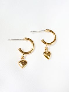 "Modern huggie hoop earrings with a cute little puffed heart charm. Dangling from secure sterling silver stud hoops for easy wear, these heart charms are solid with a flat back. MATERIALS [ SILVER ] sterling silver hoop, rhodium silver filled charm [ GOLD ] 14k gold vermeil hoop, 14k gold filled charm DIMENSIONS * hoops measure 11mm (7/16\") in diameter and about 1.5mm (1/16\") thick * 22mm (7/8\") length with drop * 6mm (1/4\") charm ◊ More heart jewelry: https://www.etsy.com/shop/kindlingandco Tiny Heart Earrings, Triangle Studs, Heart Hoop Earrings, Puffed Heart, Puffy Heart, Jewelry Card, Tiny Heart, Sterling Silver Hoops, Sterling Silver Studs