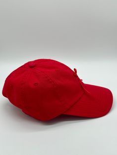 Red baseball cap featuring a red satin bow. Cap and ribbon are both vintage. Cap is unstructured and adjustable in size. Any idiosyncrasies, such as signs of wear or mending, are the result of the nature of the material’s long and rich history and should not be considered flaws or damage. Classic Red Baseball Cap With Curved Bill, Classic Red Hat With Curved Bill, Classic Red Curved Bill Hat, Classic Red Dad Hat With Curved Brim, Classic Red Baseball Cap With Curved Brim, Adjustable Red Baseball Cap, Adjustable Red Dad Hat, Red Adjustable Baseball Cap With Curved Visor, Adjustable Red Baseball Cap With Curved Visor