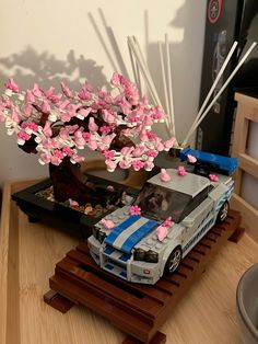 a toy car with pink flowers on it