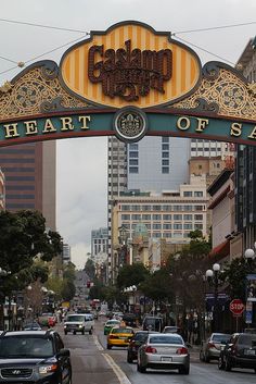 cars are driving under an arch that says heart of san francisco