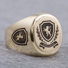 "This signet ring is crafted from 14K solid yelow gold and has a substantial feel to it with a designer quality finish. We can engrave your family crest on the top and sides of the ring and use our unique hand-crafted black finish to add contrast. We can also help you design a unique family crest using your choice of shield, symbols and text for an additional fee (please contact us for design pricing). ITEM DETAILS Item# SRGC006-FC Metal: 14K Solid Gold ITEM DIMENSIONS Width Widest Point: 18.23m Luxury Engraved Ring With Coat Of Arms For Gift, Classic Personalized Signet Ring For Collectors, Classic Personalized Collectible Signet Ring, Luxury Oval Signet Ring Stamped 14k, Luxury Oval 14k Stamped Signet Ring, Luxury Oval Signet Ring With Hallmarks, Oval Engraved Signet Ring For Collectors, Luxury Oval Engraved Ring With Engraving Option, Luxury Personalized Oval Signet Ring