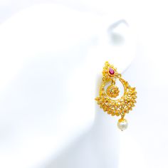 These exquisite 22k gold hanging earrings, weighing a total of 19.0 grams with a gold net weight of 16.2 grams, feature a refined and glamorous design adorned with uncut diamonds (Polki), rubies, and pearls. The yellow gold finish enhances their luxurious appeal, making them perfect for any special occasion. The uncut diamonds, totaling 1.8 carats, come in irregular round shapes, adding a unique sparkle. Complementing the diamonds are rubies and pearls, weighing 5.7 carats and shaped in spheres and pear drops, adding a touch of color and elegance. With a length of 2 inches and a hanging style, these earrings offer a sophisticated and comfortable fit, secured with screw-back posts. Ideal for those who appreciate high-quality craftsmanship and timeless beauty, these glamorous earrings are a Traditional Gold-plated Yellow Gold Pearl Earrings, Traditional Yellow Gold Plated Pearl Earrings, Traditional Yellow Gold-plated Pearl Earrings, Elegant Gold Chandbalis For Reception, Gold Temple Jewelry Pearl Earrings In 22k, Gold Kundan Filigree Earrings, 22k Gold Temple Jewelry Pearl Earrings, Traditional 22k Gold Pearl Earrings For Festive Occasion, Gold Ruby Chandbalis With Intricate Design