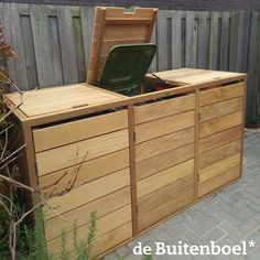 a large wooden chest sitting next to a fence